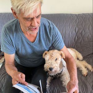 An ATRA volunteer reads a book to a WFT.